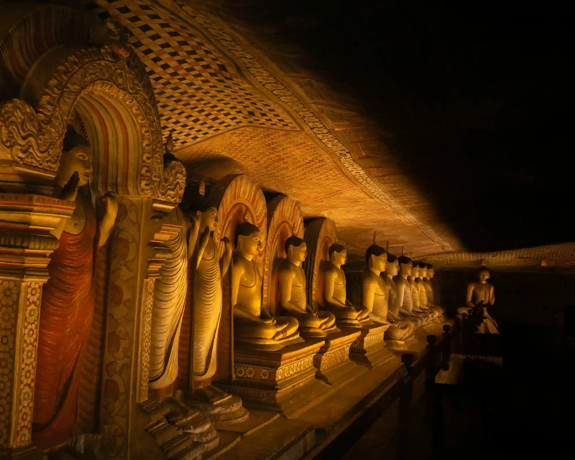 Illuminated Cave Hall with Buddha Statues