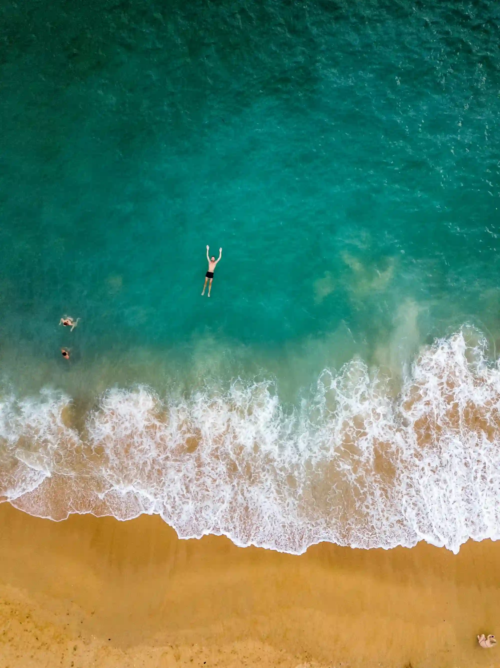 Swimmers in Turquoise Waters